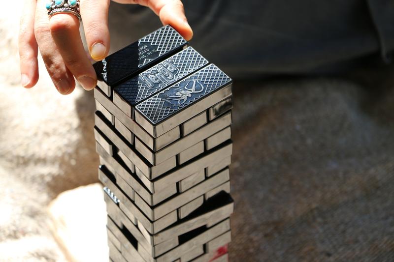 Person playing with a jenga set from Bureo on EarthHero that features sea animals and is made with recycled fishing net.