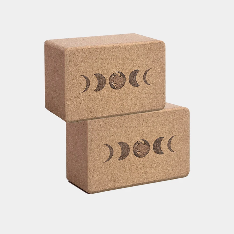 Stacked cork yoga blocks with the phases of the moon on them from the brand Scoria on EarthHero.
